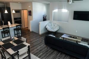 a living room with a couch and a table at Beautiful TownHome With Garage in Las Vegas in Las Vegas