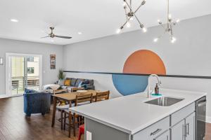 a kitchen and living room with a sink and a table at Rhythm & View - Large Groups in Nashville