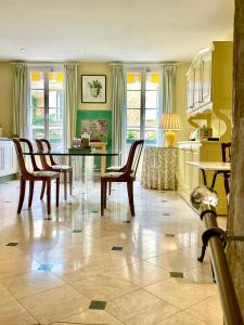 a kitchen with a dining room table and chairs at Le Logis Plantagenêt in Bergerac