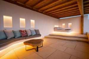 a living room with a couch and a table at Utopia Suites by Anna Platanou in Agia Irini Paros