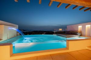 a swimming pool with a water fountain on a building at Utopia Suites by Anna Platanou in Agia Irini Paros
