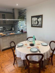 a table in a kitchen with a white table cloth at Anzio (RM), zona Santa Teresa in Anzio