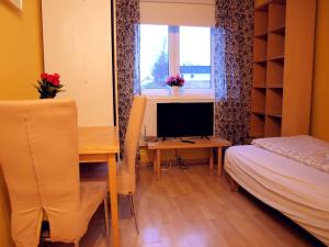 een kamer met een bureau, een computer en een bed bij Bedder at Oslo Airport - serviced apartments in Jessheim