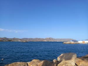 a large body of water with rocks in the foreground at Casa Bart de vacaciones in Mazarrón