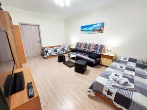a living room with two beds and a couch at Апартамент за гости, ж.к. Зорница , бл.9 in Burgas City