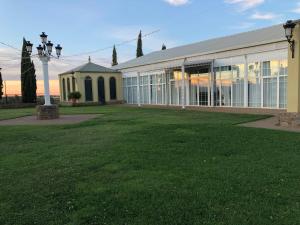 un gran edificio con un campo de césped delante de él en Apartamentos Atalayas Extremadura, en Zafra