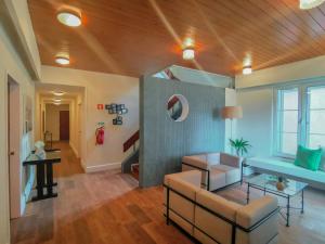 a living room with a couch and a table at Garden's Nest - North Villa in Conceição