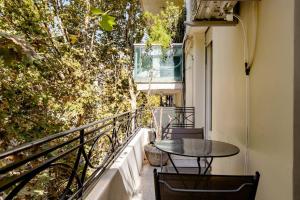 a balcony with a table and chairs on it at A Friendly Room in the Heart of Recoleta -in Shared Apartment- in Buenos Aires