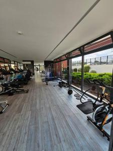 a gym with a bunch of treadms and machines in it at River Terrace & Pool View - Seixal in Seixal