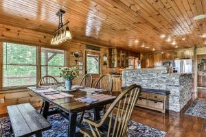 a dining room with a table and chairs and a kitchen at The High Life LONG RANGE VIEWS OF THE BLUE RIDGE MOUNTAINS in Mineral Bluff