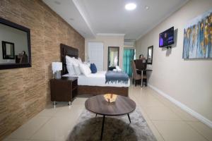 a hotel room with a bed and a table at Bayside Hotel Pinetown in Pinetown