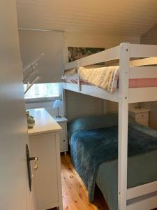 a small bedroom with a bunk bed and a desk at Chalet Sint-Hubertus in Zutendaal