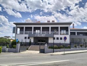 a white building with a sign on top of it at Villa Rey Spa & Hotel in Vila de Rei