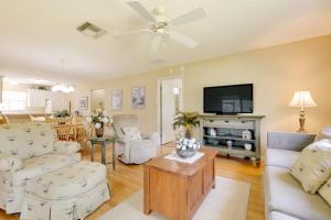 a living room with a couch and a tv at Lanai and Golf Cart The Villages Vacation Rental! in The Villages