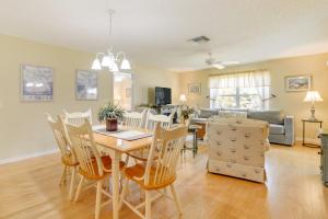 a dining room and living room with a table and chairs at Lanai and Golf Cart The Villages Vacation Rental! in The Villages