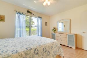 a bedroom with a bed and a dresser and a window at Lanai and Golf Cart The Villages Vacation Rental! in The Villages +25 photos