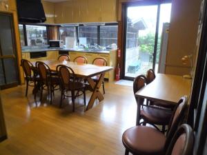 a kitchen and dining room with a table and chairs at GuestHouse AZMO - Vacation STAY 84356v in Matsue