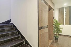 a staircase in a house with a potted plant at Super Townhouse Rcc Pride in Hyderabad