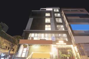 a tall building with a store in front of it at Super Townhouse Rcc Pride in Hyderabad +33 photos