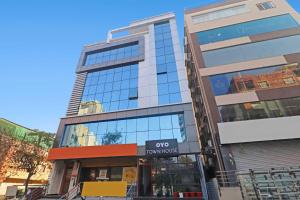 a building with a sign that reads promises at Super Townhouse Rcc Pride in Hyderabad +36 photos