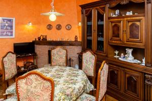 a dining room with a table and chairs and a fireplace at GB - Dimora Fiorita in Armeno