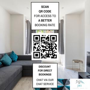 a living room with a grey couch and a qr code sign at Spacious 3BR House Near Southend Pier in Southend-on-Sea