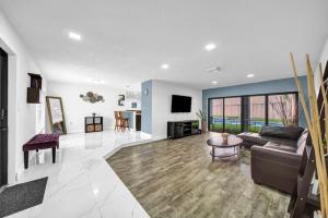 a living room with a couch and a table at Modern Lux Pool Home Upscale, Spacious and Comfy in Kendall