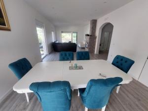 a white table and blue chairs in a room at Harmony house in Bar