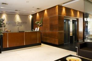 a lobby with a reception desk in a building at Uriburu 1756 by Ayres Apartments Recoleta in Buenos Aires +37 photos