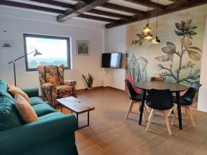 a living room with a couch and a table and chairs at LA LÍNEA DEL MAR in Trasierra