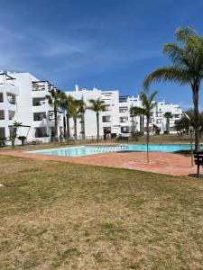 a swimming pool in front of a apartment building at Vista Verde in Murcia