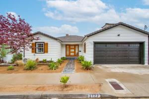 a white house with a garage at The California III in San Diego