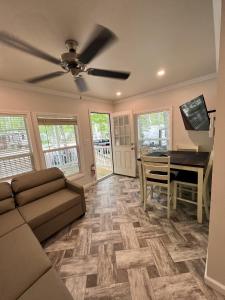 a living room with a couch and a piano at HTR Adirondacks in Old Forge