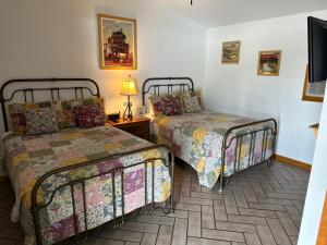 a room with two beds and a television in it at Buffalo Chip's Ranch House Motel in Bonita Springs