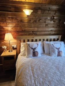 a bedroom with a bed with two deer heads on it at Hillhaven Lodge in Inverness