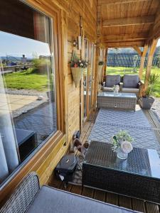 a screened in porch with a table and a patio at Hillhaven Lodge in Inverness