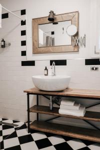 a bathroom with a sink and a mirror at Tra le case di Reggio - Passo Buole in Reggio Emilia