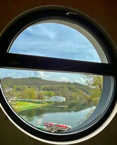 a view of a lake through a window at Wohntraum Boardinghouse in Olpe