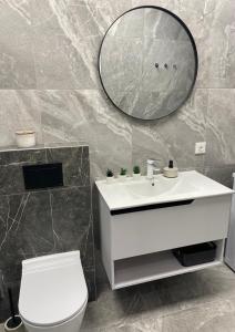 a bathroom with a white sink and a mirror at Studio46 in Klaipėda