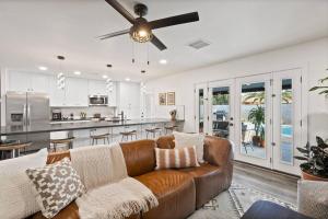 a living room with a couch and a kitchen at El Descanso in Meyer Park - Heated Pool in Tempe