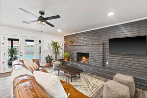 a living room with a couch and a fireplace at El Descanso in Meyer Park - Heated Pool in Tempe