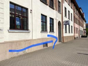 a blue ribbon on the side of a building at Studio46 in Klaipėda
