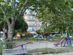 a playground with a slide in a park at Apartments Villa Effie in Paralia Katerinis