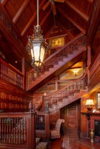 a large library with stairs and a chandelier at Ivy Lodge in Newport