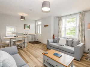 a living room with a couch and a table at Gamekeepers Cottage in Titchwell