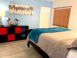 1 dormitorio con 1 cama y una ventana con palmeras en Home Sweet Home Near Malls and Airport and Hwy, en South Miami