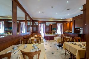 a restaurant with tables and chairs and a bar at Hotel Diplomate in Geneva