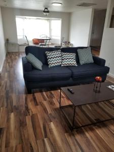 a living room with a blue couch and a table at 3 Bedroom By River Park & Trails in Loveland
