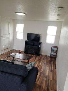 a living room with a couch and a table and a television at 3 Bedroom By River Park & Trails in Loveland