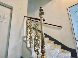 a gold stair railing next to a set of stairs at Gold Room in Vienna